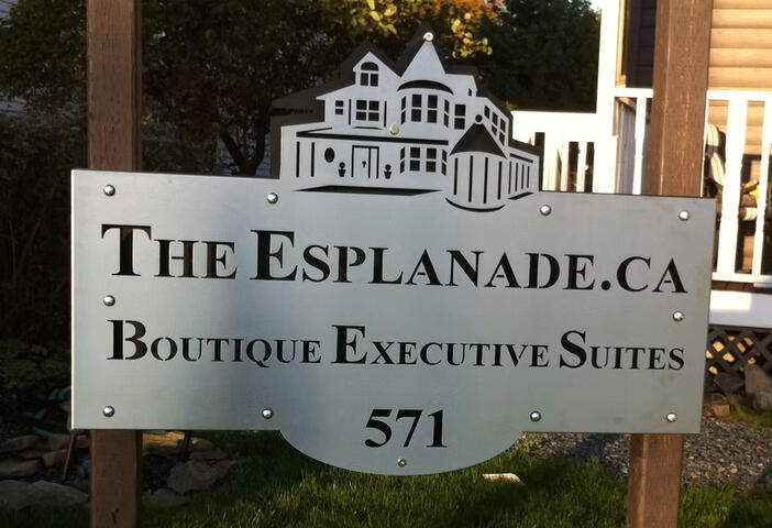 Exterior sign. Post mounted. Contrasting backplate.